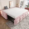 A pink sofa bed is shown fully extended as a bed with a white mattress on a rug in a room. Podgląd zdjęcia produktu