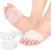 A close-up shot of two feet wearing silicone toe separators, with two additional separators in the foreground. Podgląd zdjęcia produktu