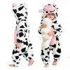 A baby wearing a cow costume, holding a stuffed animal. Produktbild-Vorschau