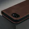 A close-up shot of a brown leather iPhone case, showing the stitching and the camera cutout. Produktbild-Vorschau