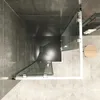 A top-down view of a modern shower cabin with glass doors and dark gray tiled walls. Produktbild-Vorschau