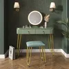 A vanity table with a mirror and stool in a room with patterned wallpaper. Produktbild-Vorschau