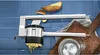 A potato press is shown in use, pressing potatoes into thin strands. Potatoes and salt are also visible. Produktbild-Vorschau