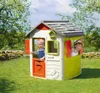 Two children playing in a colorful playhouse in a grassy yard. Produktbild-Vorschau