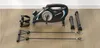 A mini exercise bike and its accessories are laid out on a wooden floor. Náhľad obrázku produktu