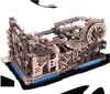 A complex wooden marble run model with intricate gears and tracks, illuminated by blue LED lights underneath. Produktbild-Vorschau
