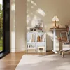 A modern office or living space with a cube shelf filled with books and decorative items, next to a height-adjustable desk and an office chair. Sunlight streams through a large window. Náhľad obrázku produktu