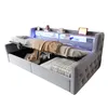A grey upholstered bed frame with storage compartments and LED lighting. Náhled obrázku produktu