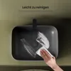 A hand is cleaning a dark gray ceramic sink with a white cloth. Produktbild-Vorschau