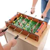 Two people playing with a mini foosball table. Podgląd zdjęcia produktu