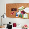 A desk with a corkboard, lamp, laptop, and phone. Produktbild-Vorschau