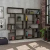 A modern living room with a large, modular bookshelf filled with books and decorative items, next to a window with a brick wall. Náhled obrázku produktu