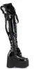 A single black patent leather boot with a platform sole, shown from the side. Produktbild-Vorschau
