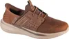 A single brown Skechers slip-on shoe is shown against a white background. Voir les images du produit