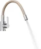 A kitchen faucet with a flexible beige spout and water spraying from the end. Anteprima dell’immagine prodotto