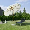A garden scene with a sun umbrella and a lounge chair. Produktbild-Vorschau