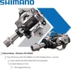 A product shot of Shimano pedals with accompanying text detailing the package contents. Produktbild-Vorschau