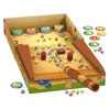 A tabletop game with a pirate theme, featuring a cannon launcher, marbles, and various game pieces. Produktbild-Vorschau