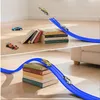 A toy car race track set is shown set up on a wooden floor, with books used as ramps and supports. The image is split into two parts, showing different angles and stages of the race. Produktbild-Vorschau