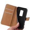 A hand holding a black phone case open, revealing the inside of a brown wallet-style case with card slots. Produktbild-Vorschau
