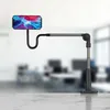 A smartphone holder with an adjustable arm and base, placed on a marble surface in front of a blurred office background. Náhľad obrázku produktu