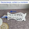 A white wooden shelf unit being assembled, with blue arrows indicating how parts connect. Produktbild-Vorschau