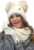 A woman wearing a winter hat, scarf, and gloves. Produktbild-Vorschau