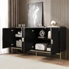 A black sideboard with gold legs is shown with its doors open, revealing storage compartments. Decorative items and boxes are placed inside. Produktbild-Vorschau