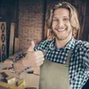 A man in a workshop is giving a thumbs up. Produktbild-Vorschau