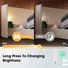 A split image showing a bed with a headboard and side tables, demonstrating different lighting modes for reading and sleeping. The right side shows a person in bed, while the left side shows the bed empty. A slider bar indicates brightness control, and tex Produktbild-Vorschau