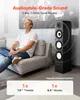 A man is sitting on a couch in a living room, listening to music from a tower speaker. Produktbild-Vorschau