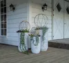 Decorative spheres with lights in planters on a wooden deck outside a house. Produktbild-Vorschau