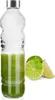A clear glass bottle filled with green liquid, next to sliced limes and a basil leaf. Náhled obrázku produktu