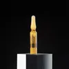 A single ampoule of MartiDerm Black Diamond Skin Complex+ is displayed on a clear, faceted pedestal against a black background. Produktbild-Vorschau