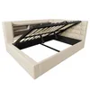 A beige upholstered bed frame with the mattress support mechanism lifted to reveal the storage space underneath. Voir les images du produit
