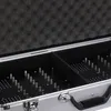 A close-up view of the interior of a silver carrying case with black foam lining and dividers. The case has multiple small metal pegs arranged in rows, likely for holding electronic devices. Náhled obrázku produktu
