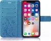 A blue flip case for an iPhone XR is shown open, displaying the phone's screen and the inside of the case with card slots. Produktbild-Vorschau