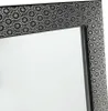 A close-up view of a mirror frame with a decorative pattern. Náhľad obrázku produktu