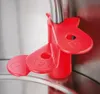 A close-up of a red plastic attachment with cup markings on a silver kettle spout. Produktbild-Vorschau