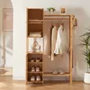 A wooden garment rack with shelves, displaying clothes, shoes, and a handbag. Produktbild-Vorschau