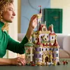 A woman is building a LEGO castle. Produktbild-Vorschau