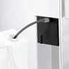 A close-up view of a flexible tube connecting a white container to a black adapter. The tube is curved and appears to be transferring liquid. Anteprima dell’immagine prodotto