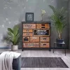 A vintage-style apothecary cabinet is shown in a room with plants and a rug. Podgląd zdjęcia produktu