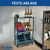 A metal shelving unit displaying bottles of wine and crates of tomatoes, with a plant on the top shelf. The unit is placed against a white brick wall. Produktbild-Vorschau