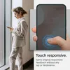 A woman is looking at her phone while a close-up of a phone screen with a fingerprint sensor is shown. Podgląd zdjęcia produktu