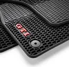 A close-up view of black car floor mats with a honeycomb pattern and a red 'GTI' logo. Produktbild-Vorschau