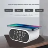 A white alarm clock with a phone charging on top, displaying the time and temperature. Produktbild-Vorschau