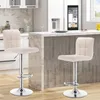 Two cream-colored bar stools are shown in a modern kitchen setting, placed in front of a marble-topped island. Produktbild-Vorschau