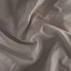 A close-up view of wrinkled taupe fabric, likely a bedsheet or duvet cover. Produktbild-Vorschau