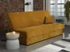 A mustard yellow sofa bed is shown in a living room setting with a small side table and a rug.